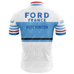 The Ford France Hutchinson Retro Cycling Jersey features a back view in white and light blue with bold FORD FRANCE and HUTCHINSON. It has lightweight polyester, blue and red striped sleeves, and the Ford logo on the shoulders.