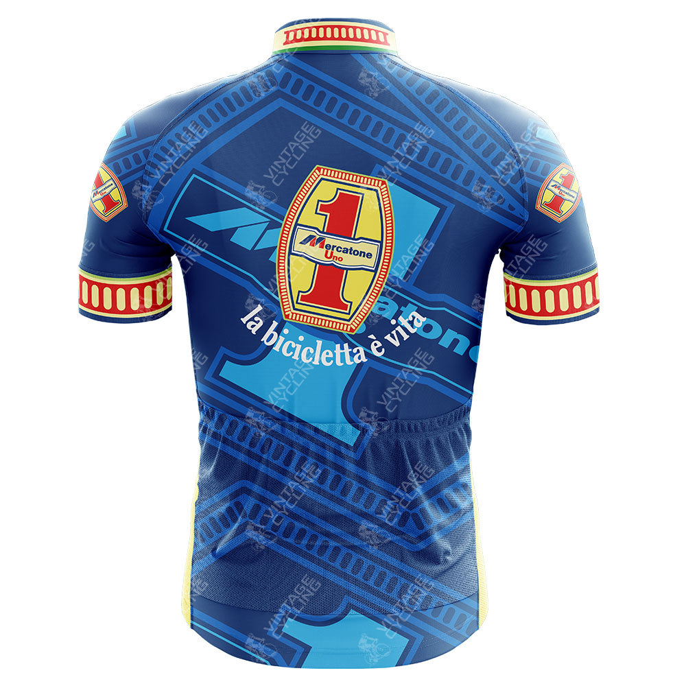 The back of the Mercatone Uno Wega Retro Cycling Jersey is blue with red and yellow trim, showcasing multiple Mercatone Uno logos. It features geometric patterns, the text la bicicletta è vita, and a striking red-detailed number 1, celebrating Marco Pantanis legacy.