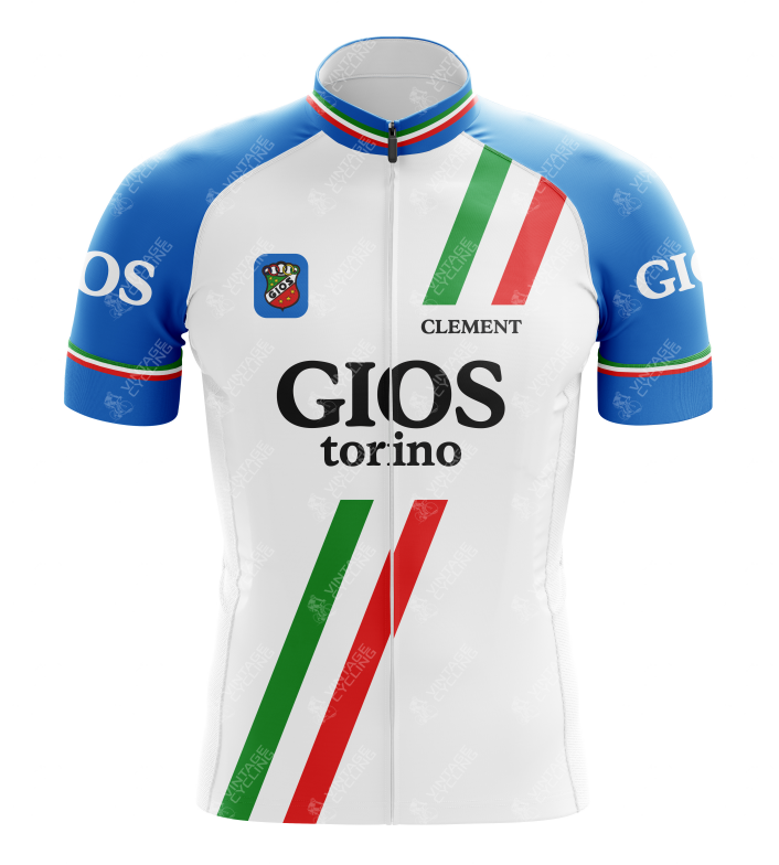 The Gios Torino Retro Cycling Jersey features blue sleeves, a white body with red and green diagonal stripes, and the GIOS torino text. It celebrates classic steel-framed bikes and includes a small chest logo patch with CLEMENT above it.