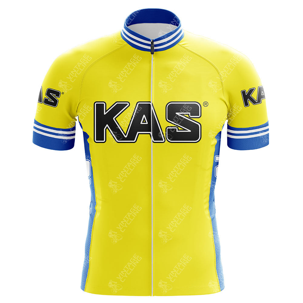 The KAS Retro Cycling Jersey is yellow and blue, featuring KAS on the front. It has blue and white striped cuffs, a collapsible collar, a full front zipper, and is made from lightweight polyester with a silicone waist strip for added stability.