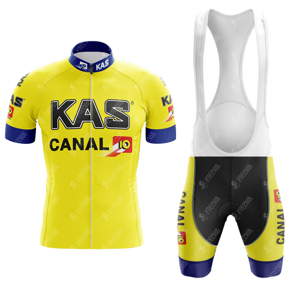 The KAS Retro Short Sleeve Cycling Set features a yellow and blue jersey with KAS and CANAL 10 logos, a front zipper, short sleeves, and collar. The coordinating bib shorts with white suspenders complete the sets cohesive design.