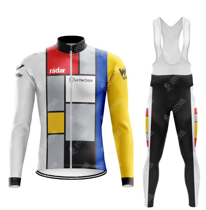 The La Vie Claire Retro Cycling Jersey Long Set, inspired by Piet Mondrian, includes a long-sleeve jersey and bib tights. The jersey has blocks of red, yellow, blue, and gray outlined in black; the mainly black tights feature matching accents. Fleece-lined options ensure extra comfort.