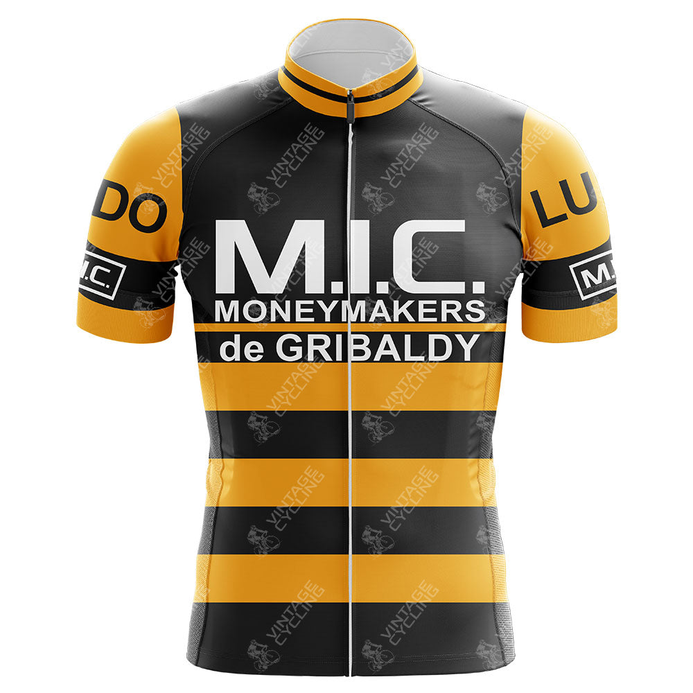 The M.I.C. Moneymakers de Gribaldy Retro Cycling Jersey, made from lightweight polyester, features yellow and black stripes with M.I.C. MoneyMakers de Gribaldy in bold text and various logos on the chest and sleeves, showcasing classic Belgian pro team style.