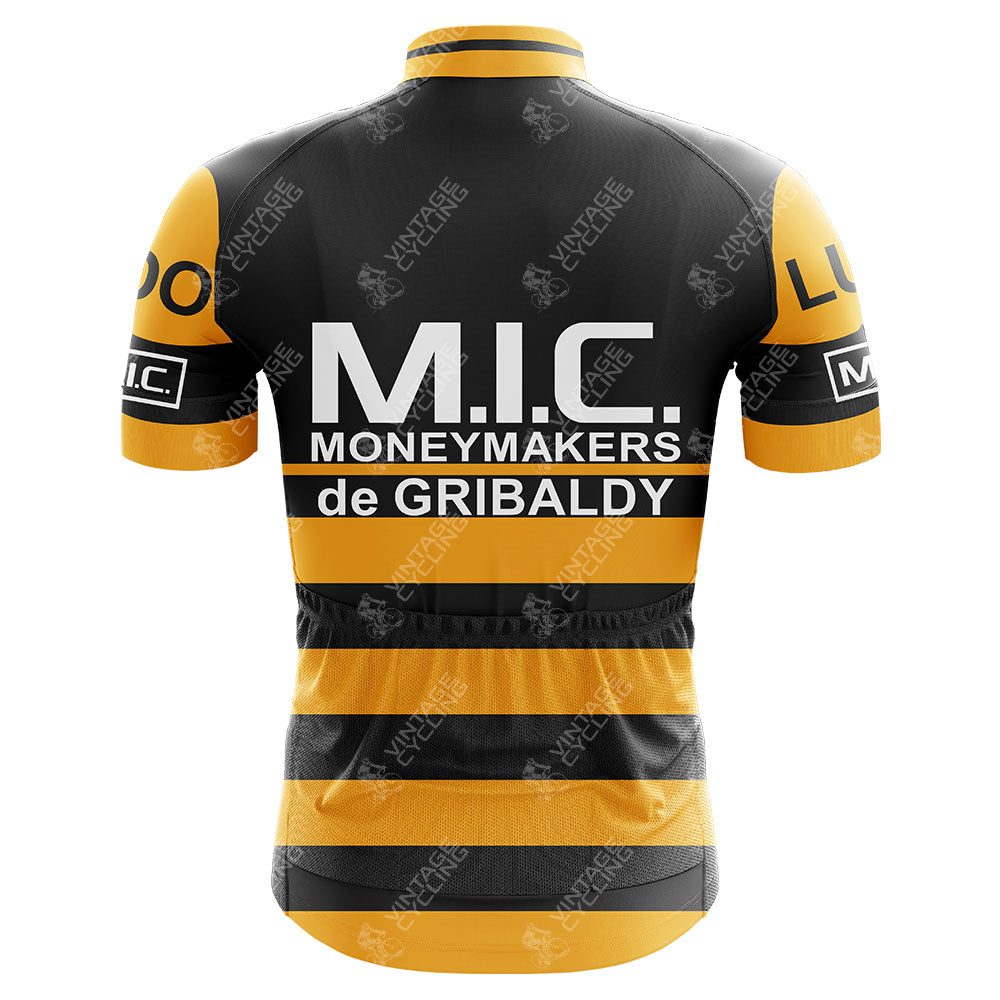 The M.I.C. Moneymakers de Gribaldy Retro Cycling Jersey sports black and yellow horizontal stripes, crafted from lightweight polyester. It boasts M.I.C. MONEYMAKERS de GRIBALDY on the back with additional sleeve details, merging a Belgian pro team look with modern comfort.