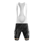 Front view of black MOLTENI bib shorts with white straps; MOLTEN printed vertically on each leg. A strip with orange, white, and green accents lines the lower edge, enhancing the retro look of the MOLTENI Black Retro Short Sleeve Cycling Set.