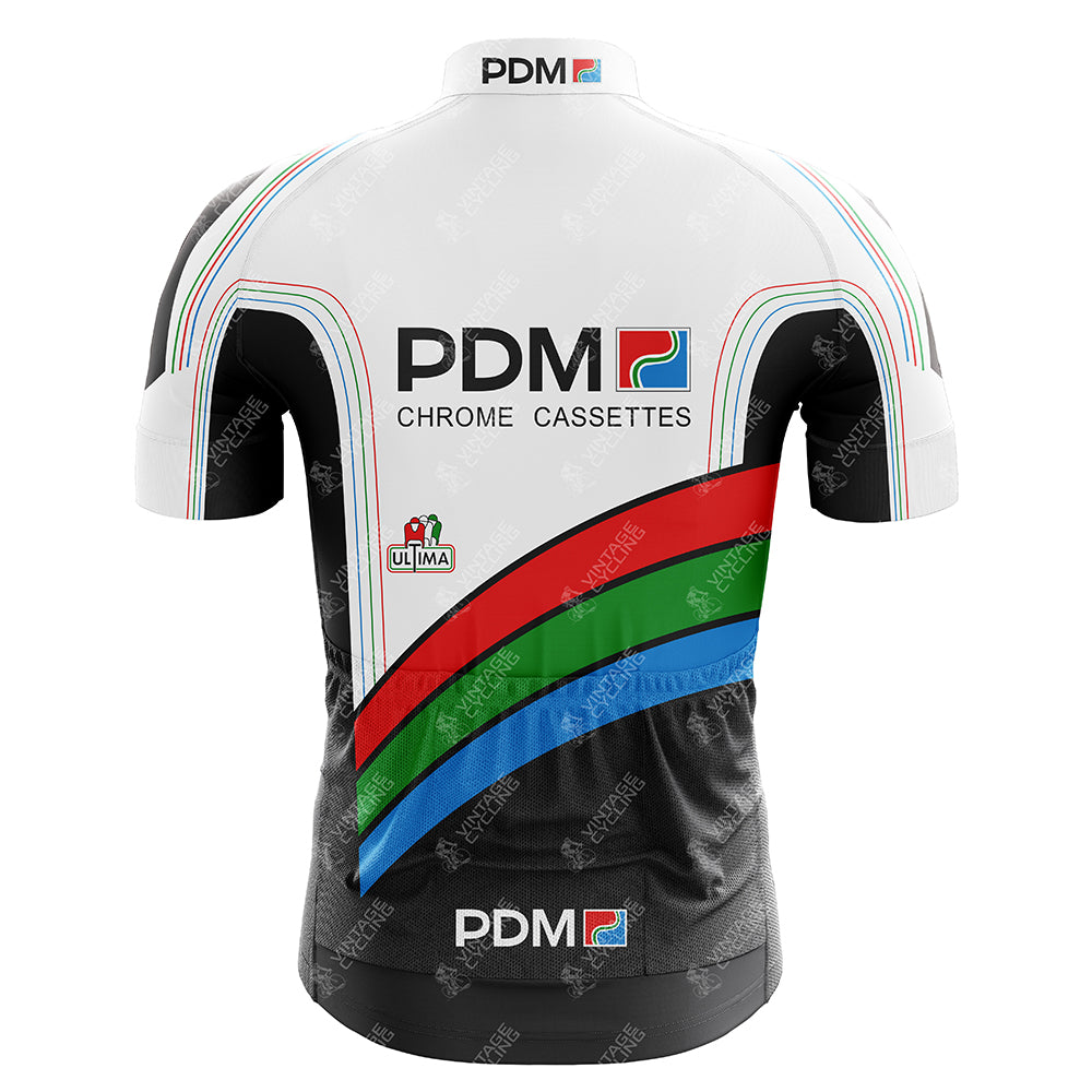 This Équipe Cycliste PDM Retro Cycling Jersey features PDM and Chrome Cassettes on the back, vertical stripes in black, green, blue, and red on a white background. An Italian flag logo with Ultima and a PDM logo complete the look near the hem.