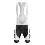 The front view of the Peugeot Black White Retro Short Sleeve Cycling Set shows vintage cycling bib shorts featuring a white and black color scheme with PEUGEOT vertically on the sides, shoulder straps, and a padded seat area.