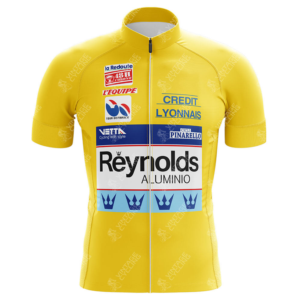 The Reynolds Aluminio Retro Cycling Jerseys, inspired by Pedro Delgados era, celebrate the iconic Tour de France with a yellow design featuring sponsor logos like Credit Lyonnais, a front zipper, and short sleeves.