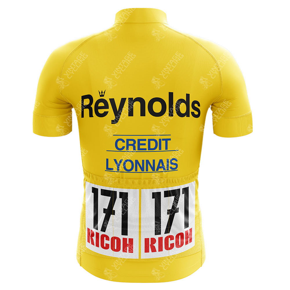 This yellow cycling jersey, inspired by the Reynolds Aluminio Retro Cycling Jerseys, features Reynolds and Credit Lyonnais text with two race numbers reading 171 over RICOH. Made from breathable material, its short sleeves echo the spirit of the Tour de France.