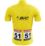 The Team Bic Retro Yellow Cycling Jersey features a cartoon figure with a pen and the logo, race number 51, and labels such as LÉquipe, Luis Ocana, and Le Coq Sportif. It commemorates the 1973 Tour de France victory.