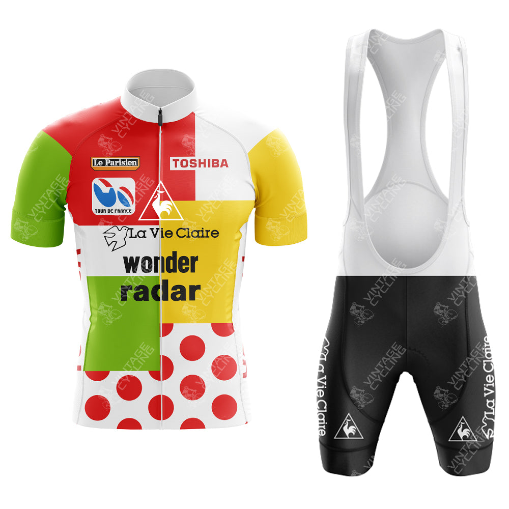 Discover the vivid Bobet Hutchinson BP Retro Short Sleeve Cycling Set, featuring a multicolored jersey with red, yellow, green, and white polka-dot sections and La Vie Claire text. It pairs seamlessly with black-and-white bib shorts showcasing the La Vie Claire logo.