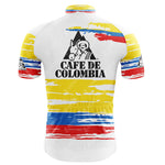 The Clas-Cajastur Retro Cycling Jersey showcases the Cafe de Colombia logo with a silhouette of a figure and mule, made from lightweight polyester. It features horizontal red, blue, and yellow stripes with vibrant sleeve patterns for performance-driven style.