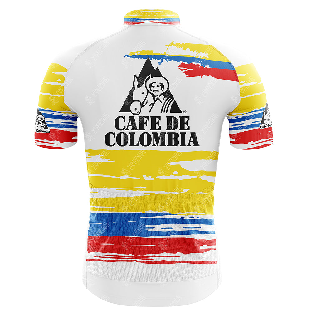The Clas-Cajastur Retro Cycling Jersey showcases the Cafe de Colombia logo with a silhouette of a figure and mule, made from lightweight polyester. It features horizontal red, blue, and yellow stripes with vibrant sleeve patterns for performance-driven style.