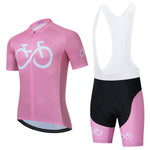 The Bike Logo Pink Cycling Jersey Set includes a pink short-sleeve jersey with a white bicycle design for style and breathability, and pink bib shorts with black accents for optimal performance. White straps on the bib complete this chic cycling ensemble.