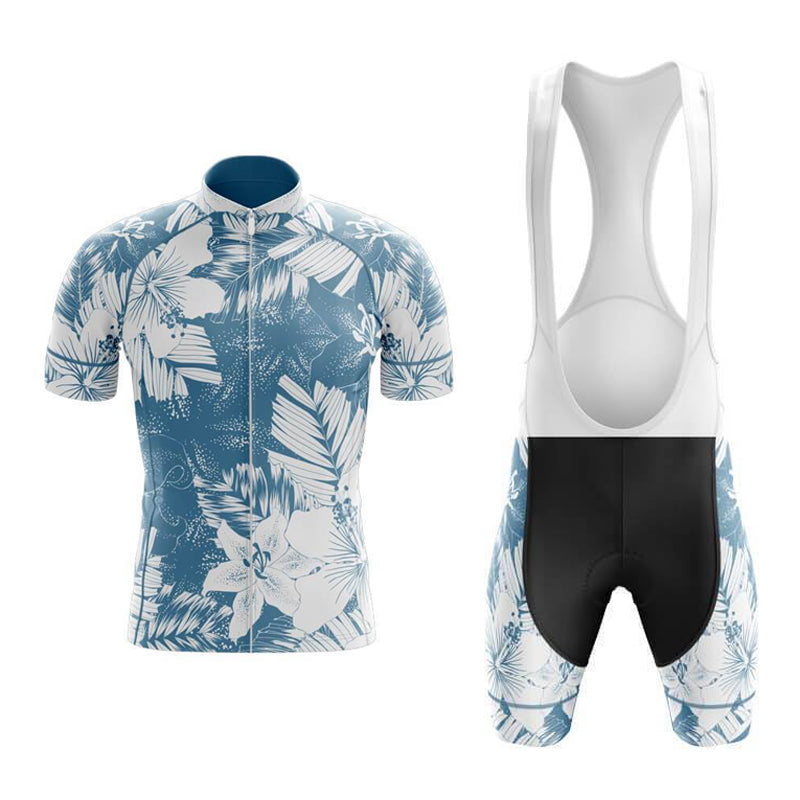 Explore the Floral Blue Lily Cycling Jersey Set, featuring a retro jersey with a blue and white floral pattern, zippered front, and high collar. The bib shorts include white straps, black shorts with matching floral designs, and a gel seat pad for added comfort.