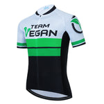 The Team Vegan Cycling Jersey is breathable and showcases green, black, and white colors with Team Vegan on the front. It features a leaf graphic, bike gear silhouette, short sleeves, and a zippered front for optimal comfort.