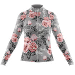 The Womens Long Sleeve Floral Grey Pink Jersey features a symmetrical pattern of pink roses and white flowers on grey. It includes a full-length front zipper and the optional fleece lining makes it ideal for cooler rides.