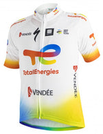 The 2021 Total Energies Vendee Cycling Jersey is made from lightweight polyester for top performance. Its white with the TotalEnergies logo in red, orange, yellow, and blue, features sponsor logos like Vendée and UCI Pro Team, and has sleeves that transition from red to blue.