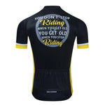 The back view of the Dont Stop Riding Cycling Jersey Set shows a black jersey with yellow accents, made from lightweight polyester. It reads, You dont stop riding when you get old, you get old when you stop riding. Features include breathable textured fabric and lower back pockets.