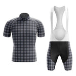 The Tartan Grey Cycling Jersey Set includes a short-sleeved retro tartan jersey in black, blue, and white shades and matching bib shorts with gel padding. The shorts are mainly black with white straps designed for comfort on long rides.