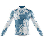 The Floral Blue Lily Cycling Jersey, available with a fleece option, features long sleeves and a striking blue and white floral pattern with large symmetrical flowers and leaves. Its zippered front and fitted shape ensure style and comfort on your rides.