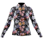 The Womens Long Sleeve Floral Cycling Jersey, available with a fleece option, is ideal for cool rides. It features vibrant florals in pink, purple, blue, and white on black for warmth and style in winter cycling.