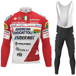 The Androni Giocattoli–Sidermec Cycling Team Long Set includes a red and white jersey with sponsor logos, black bib shorts, long sleeves for cooler rides, a front zipper, and vibrant text variations. Available with a fleece option.