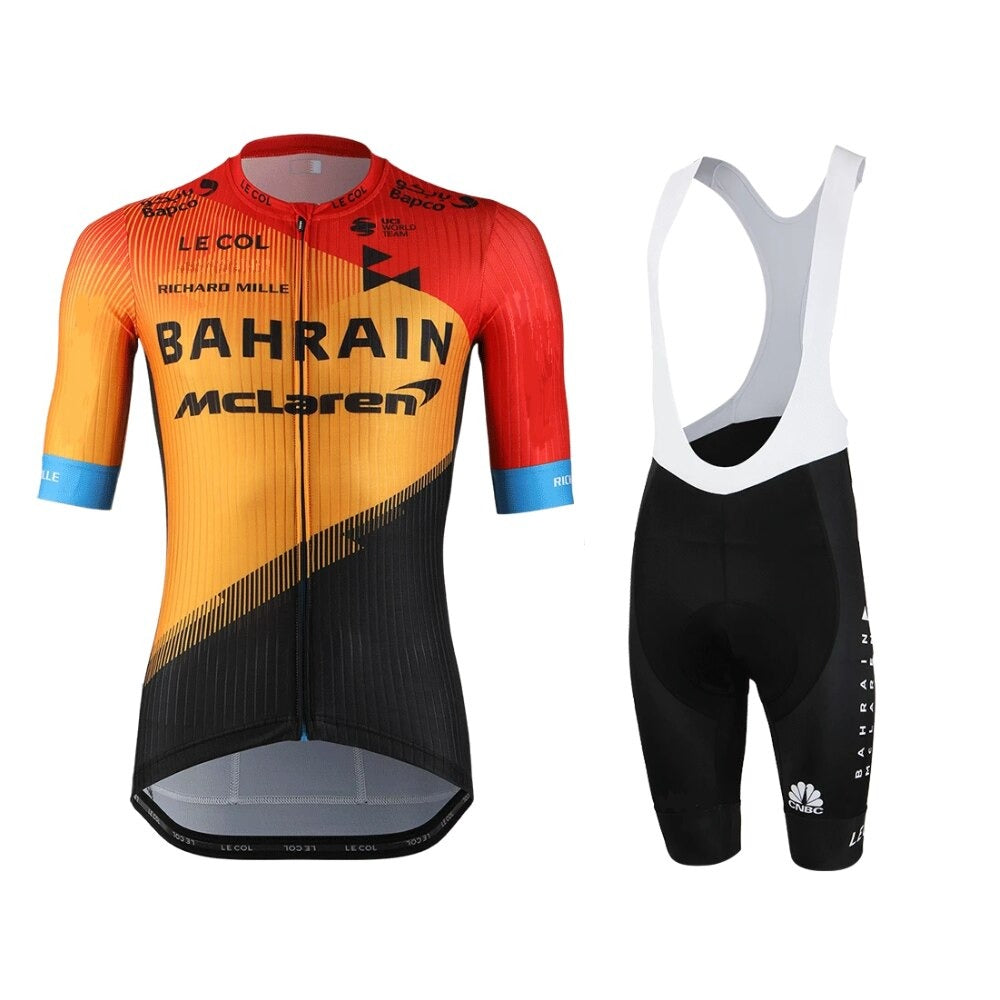 The Bahrain McLaren Le Col Cycling Team Jersey Set includes a lightweight polyester orange and black short-sleeved jersey with logos and black bib shorts featuring white straps. It offers a gel seat pad for comfort on long rides.