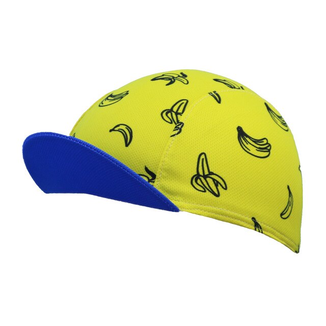 The Banana Skins Cycling Cap features a playful black banana pattern on vibrant yellow with a blue brim, made from breathable mesh fabric for moisture absorbency and comfort.