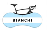 A blue and white BIANCHI banner overlays a sleek black bicycle frame, highlighting the handlebars and saddle. Retro Bianchi Bike Socks complement the scene with a nostalgic touch.