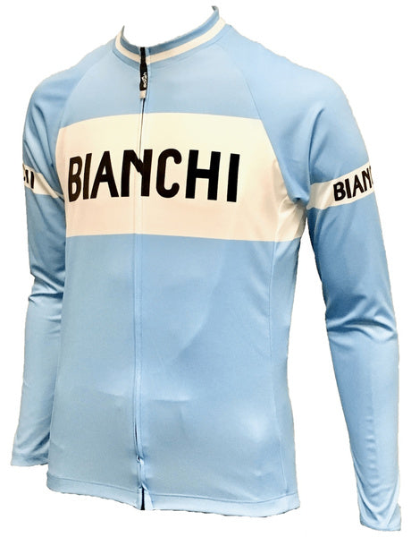 The Bianchi Retro Cycling Jersey comes in baby blue with a classic white stripe on the chest and sleeves, featuring BIANCHI in bold black letters. It includes a front zipper and long sleeves, with an optional fleece version for cooler rides.
