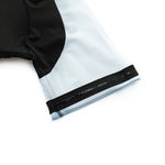 A close-up of the Big Foot Sasquatch Cycling Jersey Set shows a short-sleeve, lightweight polyester jersey with black fabric on the left and light gray on the right, featuring black and white elastic sleeve bands with a side zipper detail. The smooth fabric is form-fitting.