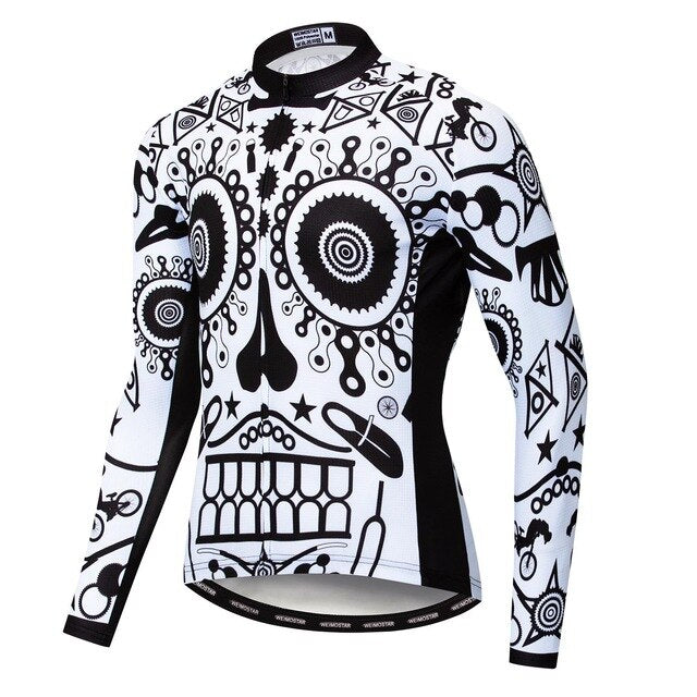The Bike Parts Skull Long Sleeve Cycling Jersey is crafted from lightweight polyester and features an intricate black and white sugar skull design, incorporating gears, stars, geometric shapes, and a central skull motif.