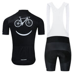The Bike Smiley Face Cycling Jersey Set includes a lightweight black polyester jersey with short sleeves, a white bike and smiley face on the back, three rear pockets, and black/white bib shorts featuring a gel seat pad for comfort.