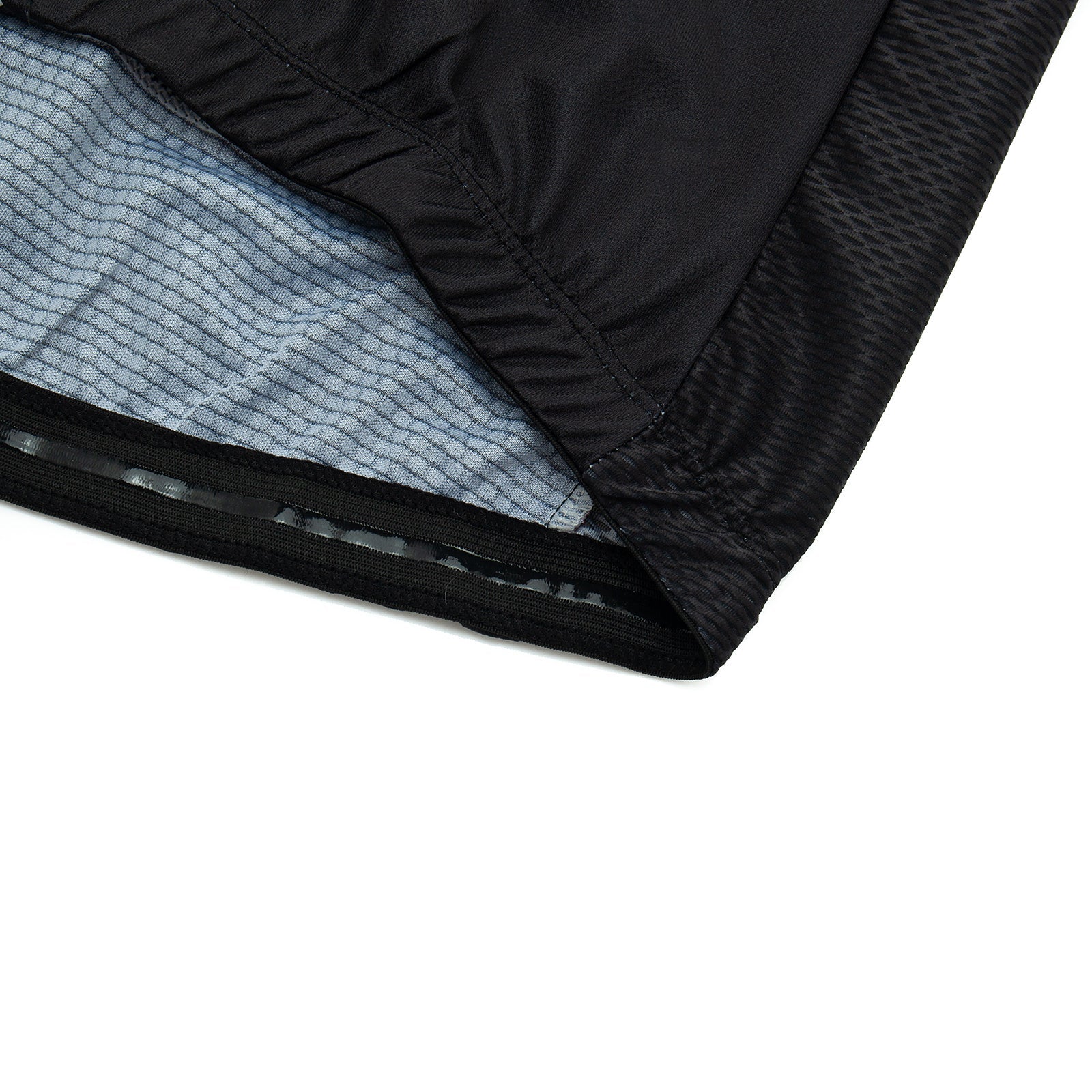Close-up of the hem of a lightweight polyester black garment with textured fabric and an inner lining featuring a light blue striped pattern, similar to the sleek design of the Bike Smiley Face Cycling Jersey Set.