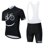 The Bike Smiley Face Cycling Jersey Set features a lightweight black polyester short-sleeve jersey with a white bicycle and smile graphic, paired with black and white bib shorts. Enjoy comfortable long rides thanks to the built-in gel seat pad.