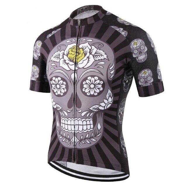 The Black & Yellow Skull Cycling Jersey features a lightweight polyester fabric with a striking sugar skull design, floral patterns, and a central yellow rose. It contrasts dark backgrounds with lighter skull motifs on the sleeves and sides and includes a convenient front zipper for performance cycling.