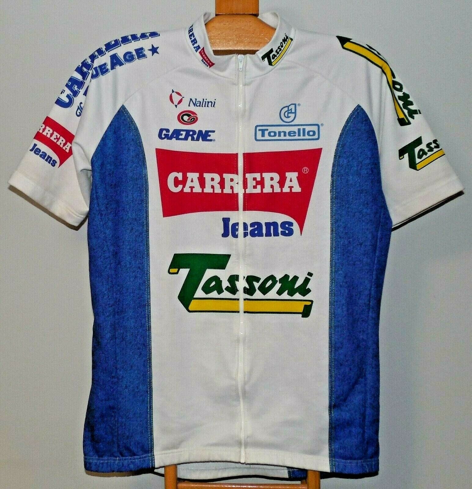The Carrera Jeans Tassoni 1993 Retro Cycling Jersey in white and blue, inspired by Marco Pantani, features short sleeves, a full zip front, collar, and vibrant logos on the chest, sleeves, and sides.