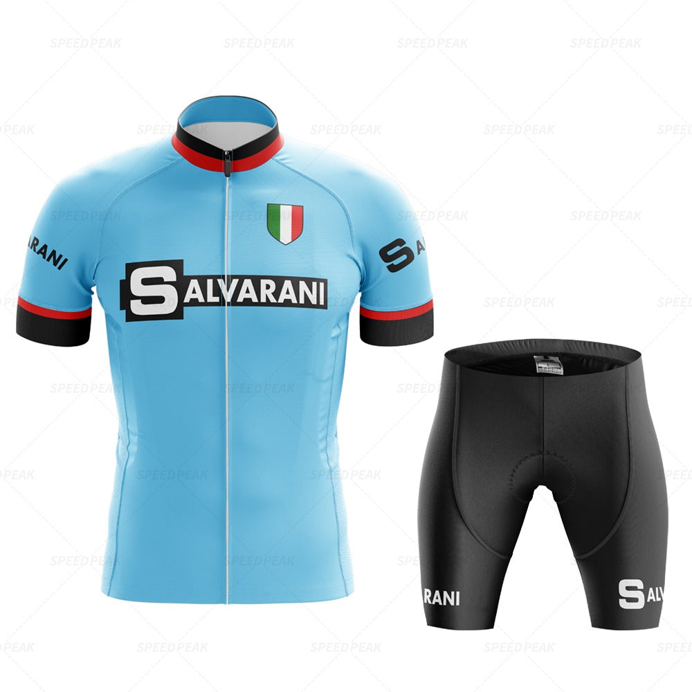 The Salvarani 1972 Retro Cycling Jersey Set includes a retro blue jersey with bold Salvarani text, the Italian flag on the chest, and black, gray, and red sleeve accents. Inspired by Felice Gimondis Grand Tours days, it pairs perfectly with black shorts featuring Salvarani text.