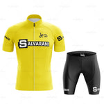 The Salvarani 1972 Retro Cycling Jersey Set showcases a vibrant yellow jersey with bold black Salvarani text across the chest, reminiscent of Felice Gimondis iconic style. It features a small logo near the collar and sleeve text, complemented by black shorts with a leg logo.