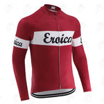 The Eroica Retro Cycling Jersey, available with a cozy fleece option, is red with long sleeves and features a white stripe across the chest and arms. Eroica is stylishly scripted in black cursive, capturing vintage cycling flair. The jersey also includes a handy front zipper.