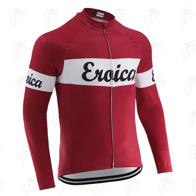 The Eroica Retro Cycling Jersey, available with a cozy fleece option, is red with long sleeves and features a white stripe across the chest and arms. Eroica is stylishly scripted in black cursive, capturing vintage cycling flair. The jersey also includes a handy front zipper.