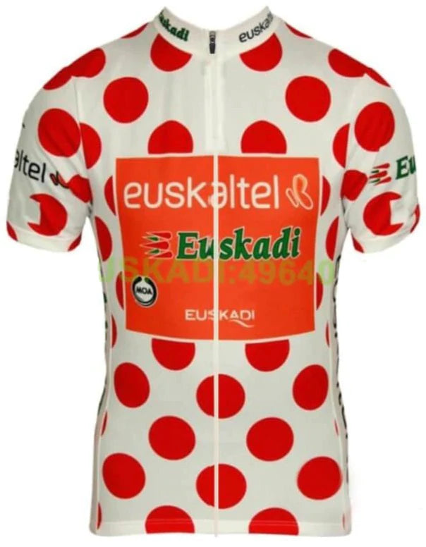 The Euskaltel-Euskadi 2003 KOM Retro Cycling Jersey features large red polka dots on a white background, Euskaltel Euskadi in vibrant orange and green on the front, and multiple logos on the sleeves and chest.