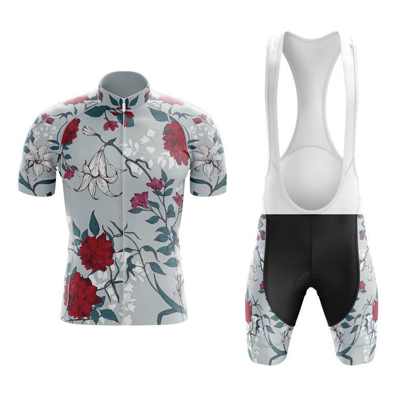 The Floral Big Red Cycling Jersey Set includes a lightweight polyester short-sleeve jersey and bib shorts featuring red roses and green vines on a gray background, with black padding in the shorts and a jersey complete with a full-length zipper for retro flair.