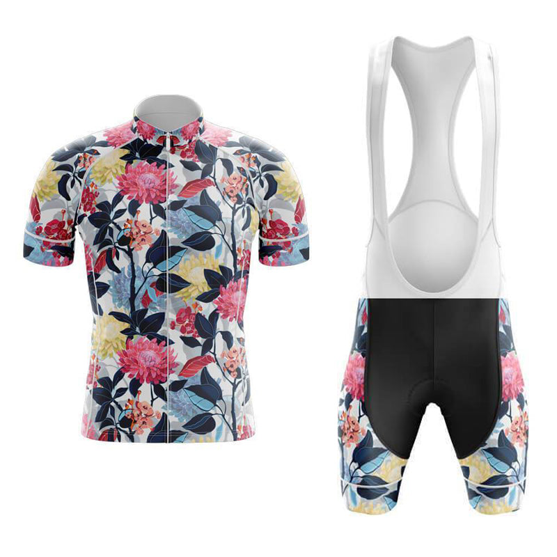 The Floral Red and Blue Cycling Jersey Set features a short-sleeve jersey with vibrant red, pink, and yellow flowers on a light background, complemented by dark leaves. The matching performance bib shorts include floral trim on the legs for a cohesive look.