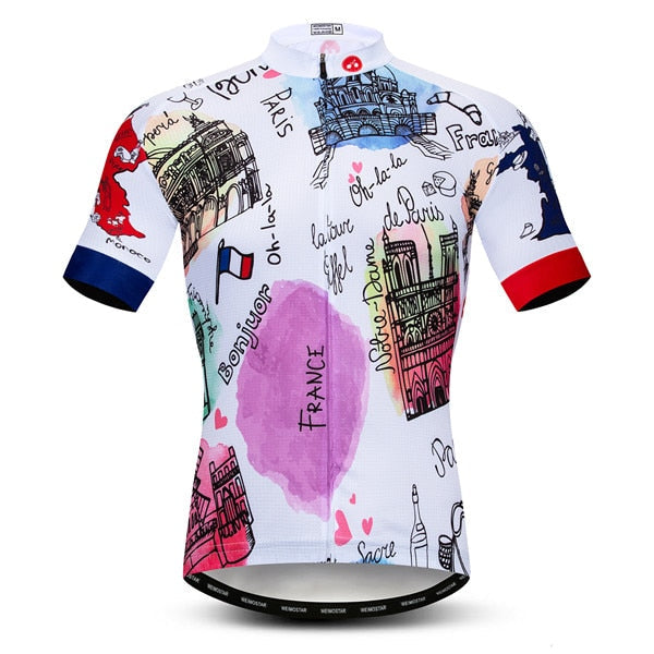 Presenting the French Postcard Cycling Jersey, a lightweight performance jersey showcasing hand-drawn Paris-themed illustrations of the Eiffel Tower and Notre-Dame, with playful Bonjour text. Its red, blue, and black accents stand out beautifully on a white background.