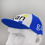 The Gan Retro Cycling Cap, displayed on a mannequin head, features a classic retro design with Gan in black letters and a yellow square accent. It has a blue brim and white side panels, offering timeless appeal reminiscent of vintagecycling.shop treasures.