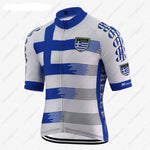 The Greece Cycling Jersey features a blue and white design with a bold Greek flag motif, crafted from lightweight polyester for performance. GREECE is printed on the sleeves and sides in blue capitals, with a badge of a shield and cross on the front.