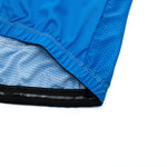 Close-up of the Bike Logo Blue Cycling Jersey Set, showcasing detailed stitching and mesh lining. The turned edge reveals its fabric texture and craftsmanship, with the vibrant blue color contrasting against a white background—ideal for performance-driven cyclists.