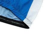 Close-up of the Big Foot Sasquatch Cycling Jersey Sets bottom edge shows a blue and gray jersey with black elastic. Made from lightweight polyester, it features a textured design where the blue section contrasts with the patterned gray.